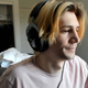 A screenshot showing xQc streaming while wearing headphones.